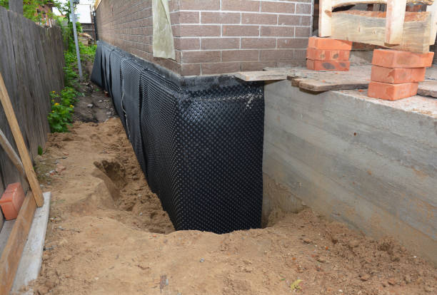 SJ Waterproofing Pros technician performing targeted Exterior Waterproofing assessment in Vallonia, IN